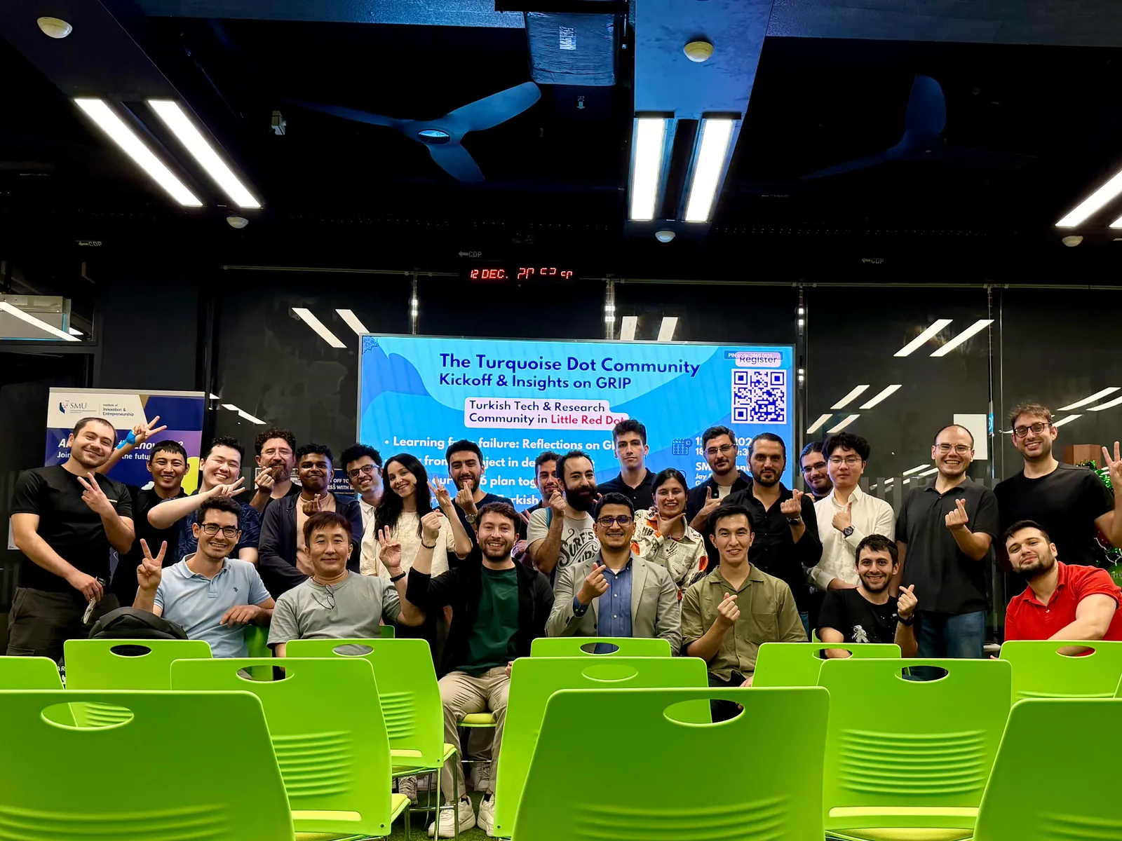 Group photo of the kickoff audience in front of the event banner at SMU Connexion